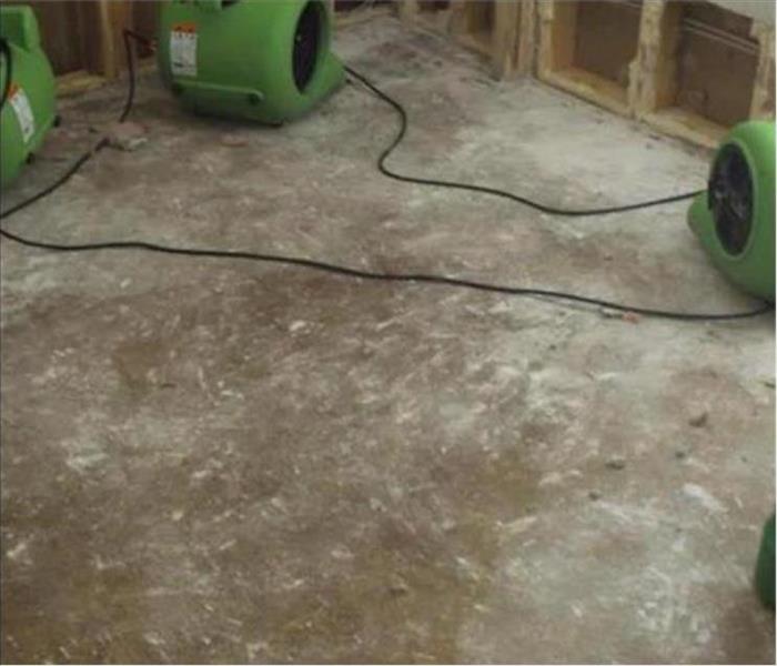 equipment drying, concrete pad and exposed walls showing studs