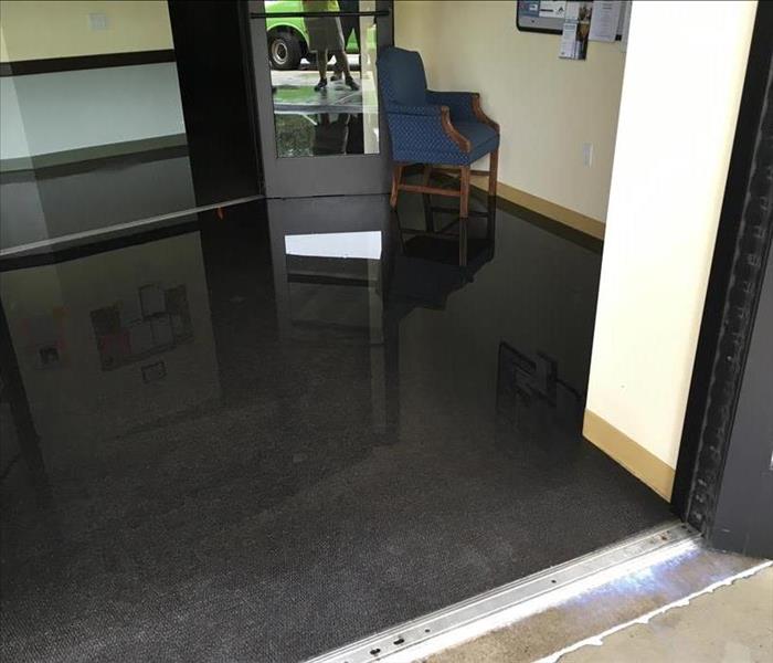 flooded surface by door and entrance of a building