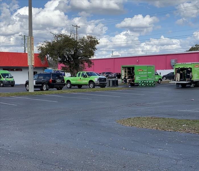 SERVPRO green vans and trucks in a parking lot